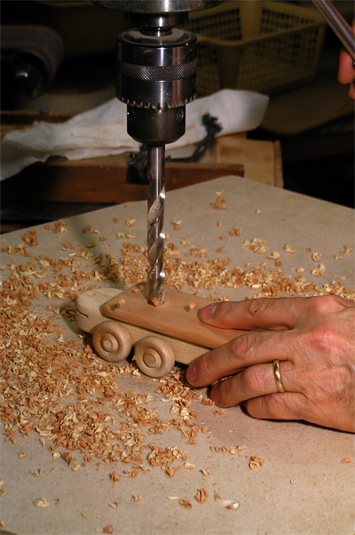 boring hole in toy train car with a drill press